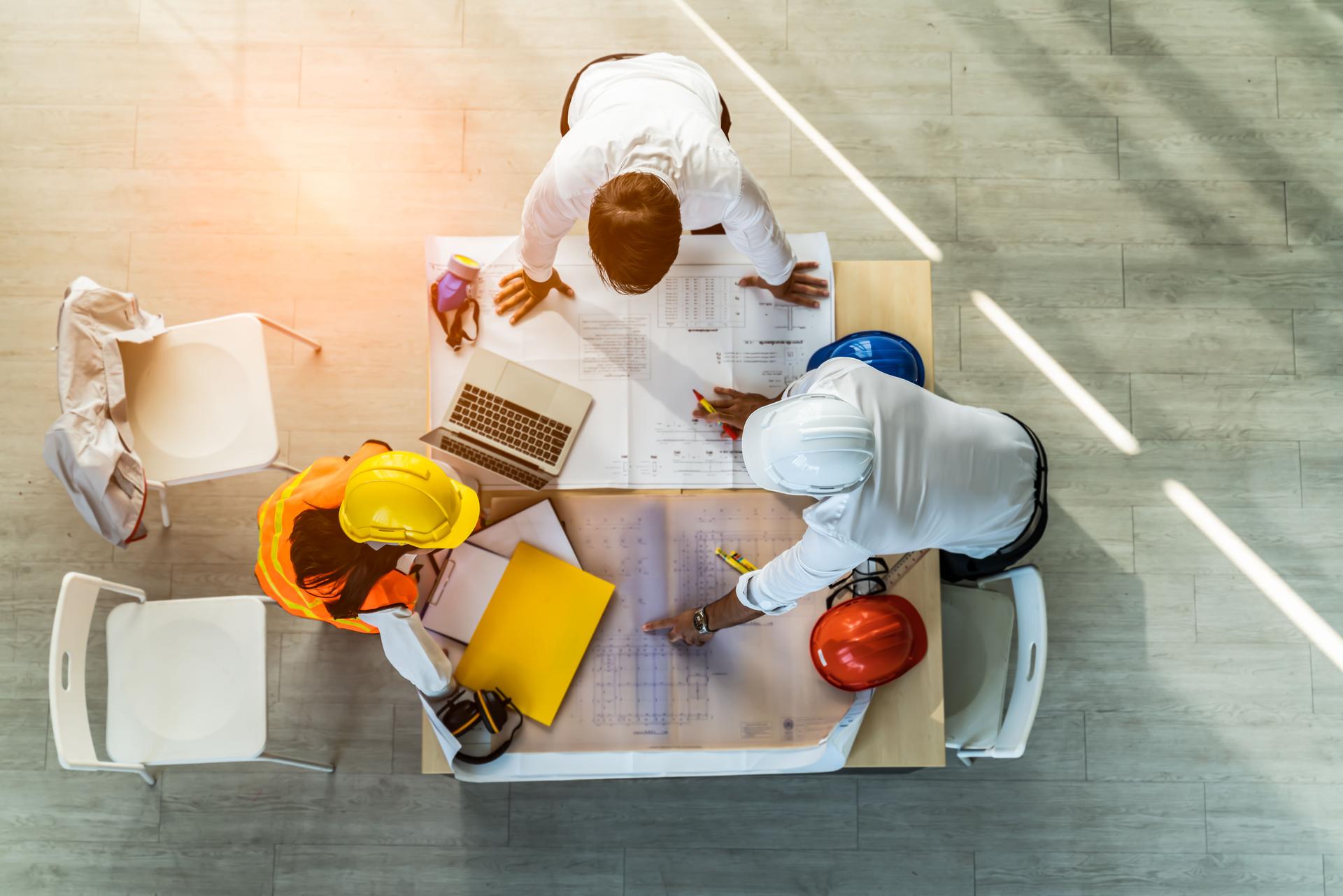 top view of Construction and structure of Creative team Engineer or architect meeting for project working with partner and tools on model building and blueprint in working site